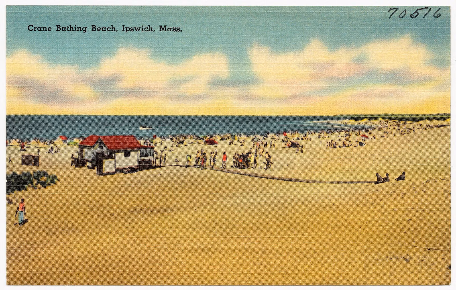 1930s postcard of a crowded Crane Bathing Beach in Ipswich, with a red-roofed beach building