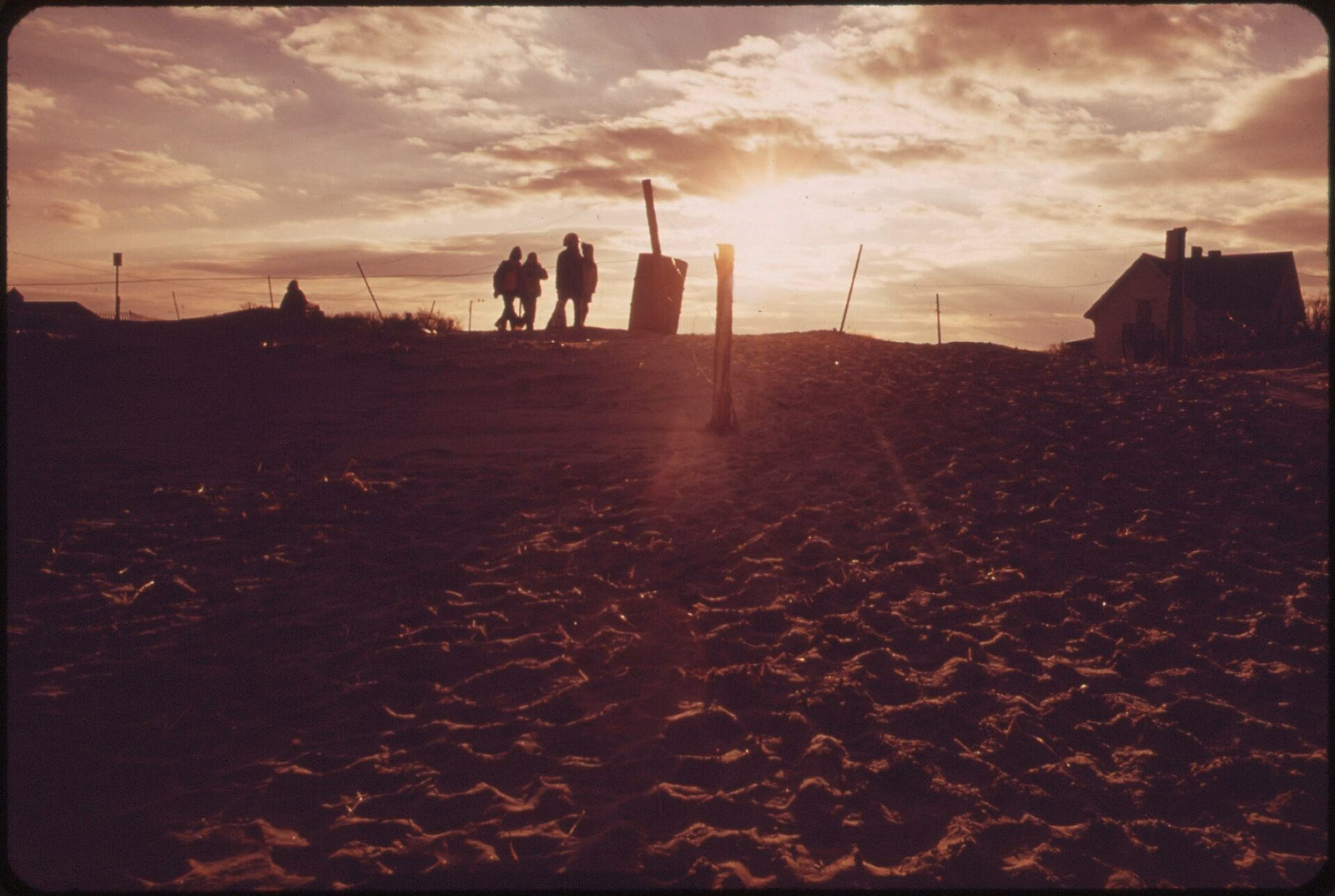 Walkers silhouetted on Crane Beach at sunset in February 1973