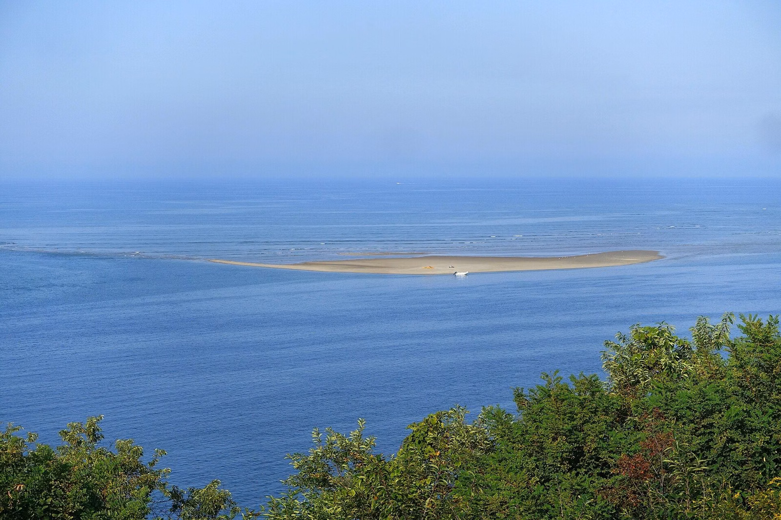 A sandbar in blue water off Crane Beach, seen from the Grand Allée at Castle Hill